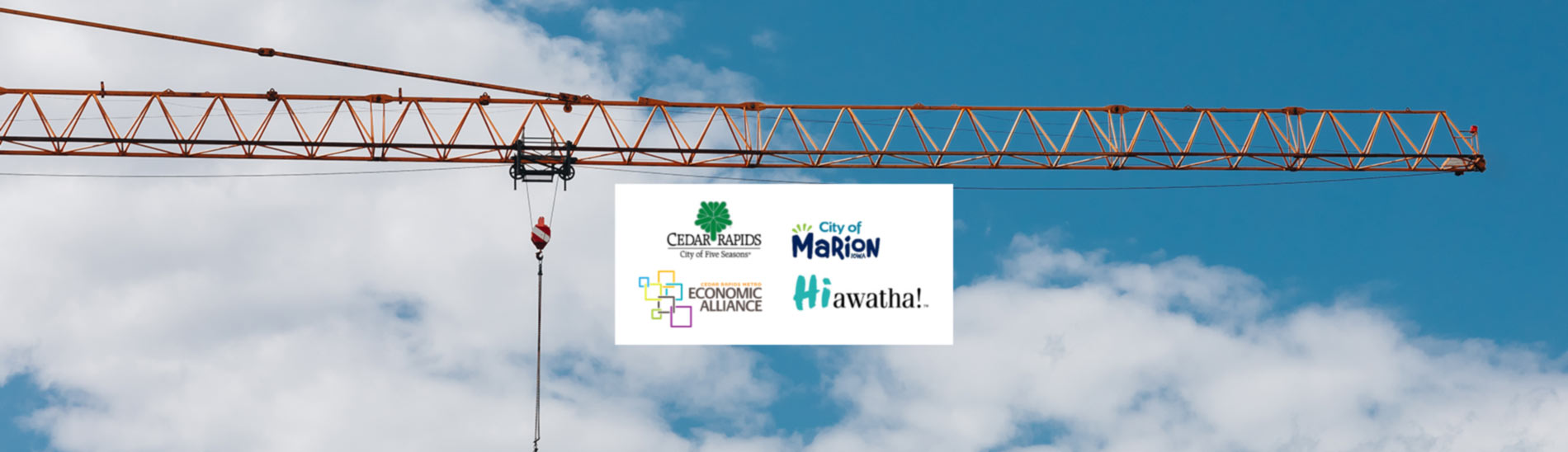 Logos of Cities of Cedar Rapids, Marion and Hiawatha and the Cedar Rapids Metro Economic Alliance set against a crane in the foreground with a partly cloudy sky.